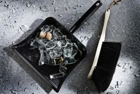 Broken glass and a dustpan and brush Broken glass and a dustpan and brush